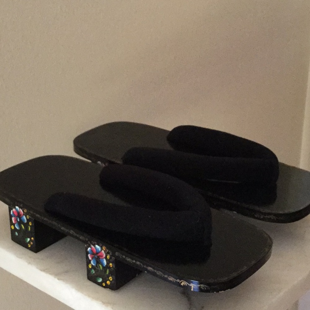 Black wooden flip flops adorned w/ bright flowers